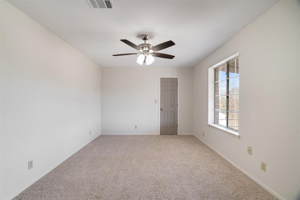374 County Road Paris, TX 75462 - Photo 17 of 38 an empty room with windows and ceiling fan