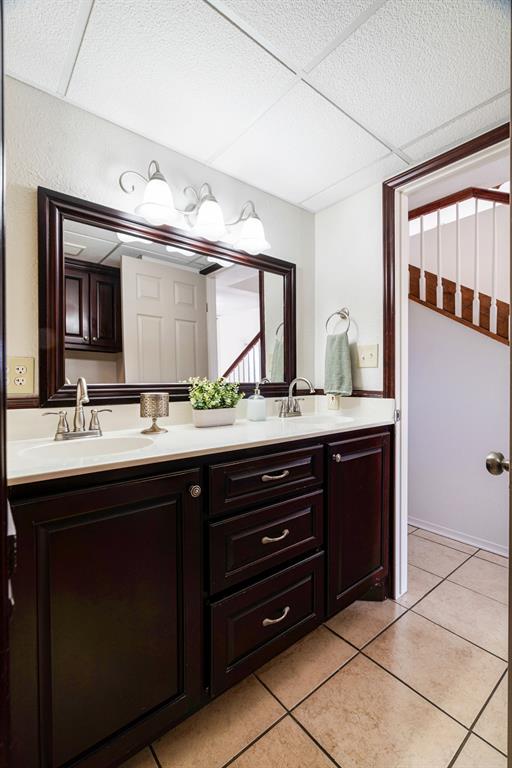 374 County Road Paris, TX 75462 - Photo 18 of 38 a bathroom with a double vanity sink and a mirror