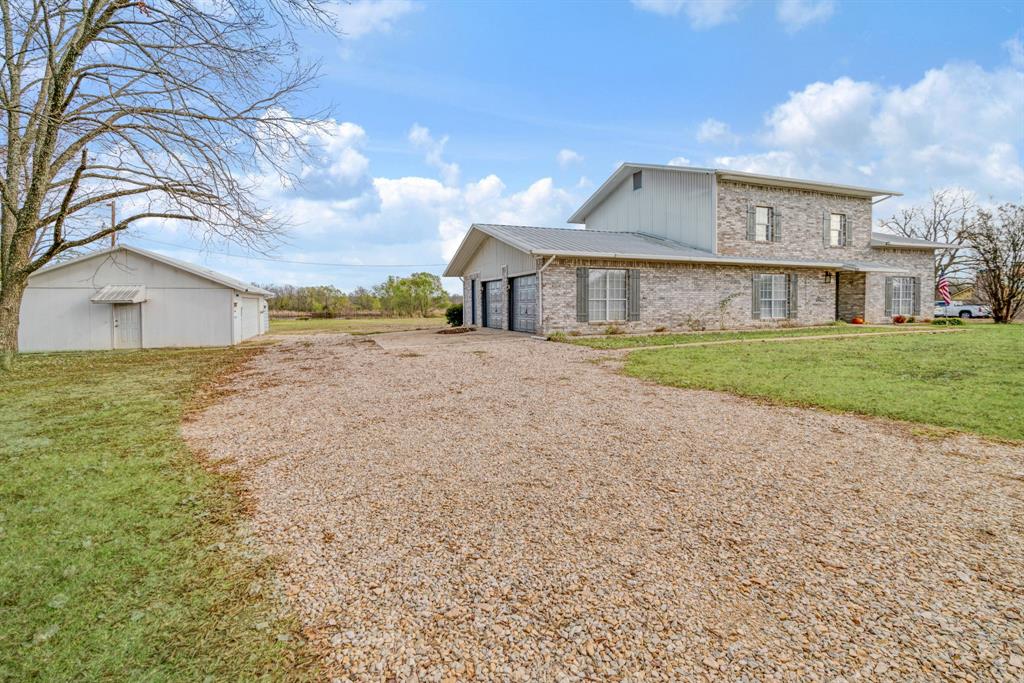 374 County Road Paris, TX 75462 - Photo 2 of 38 a view of a house with a yard