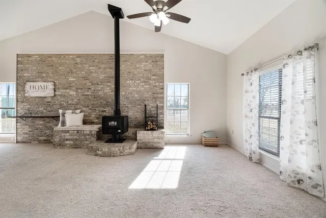 a living room with furniture and floor to ceiling window