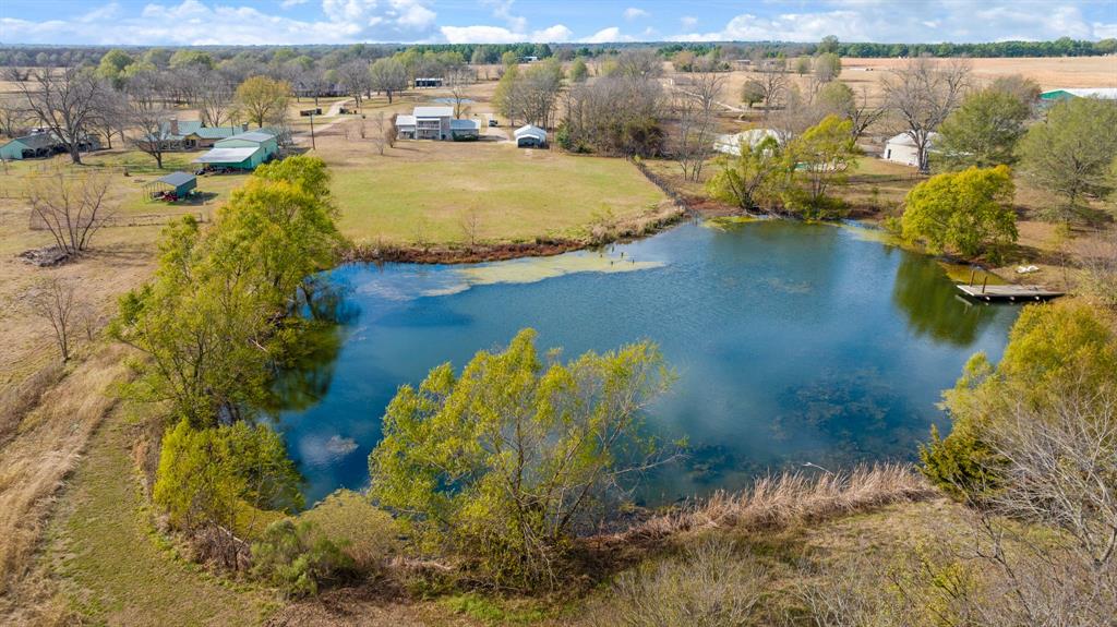 374 County Road Paris, TX 75462 - Photo 34 of 38 a view of a lake with boats and trees in the background