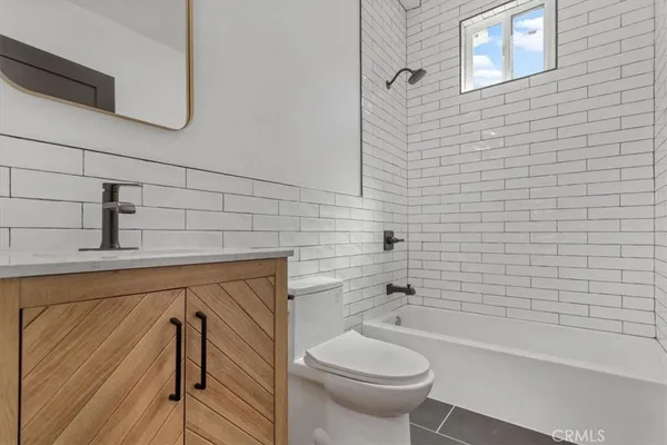a bathroom with a sink a toilet and bathtub