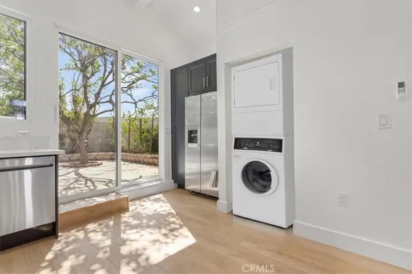 a view of a hallway with washer and dryer