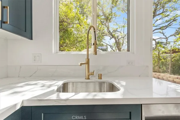 a kitchen with a sink and a window