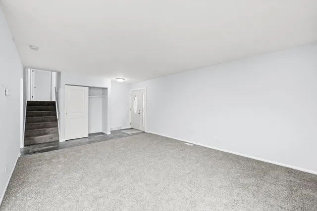 a view of an empty room with a staircase