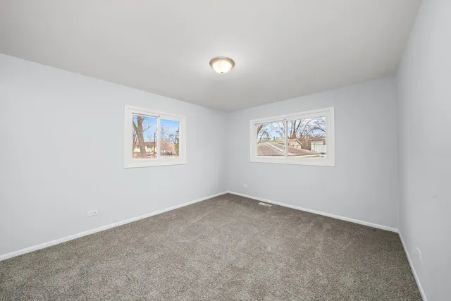 an empty room with a painting on the wall
