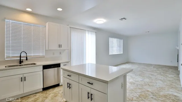 a kitchen with a sink stove top oven and cabinets