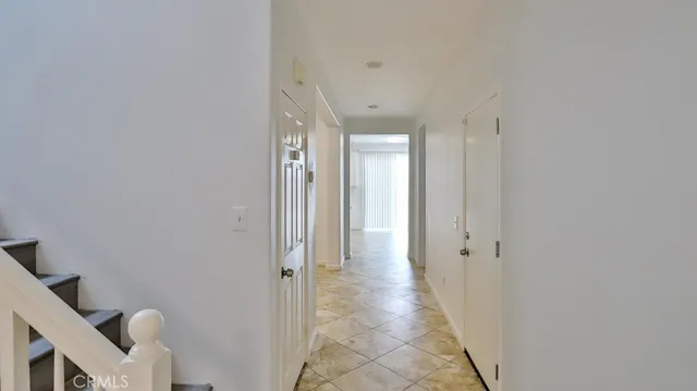a view of a hallway with wooden shelves