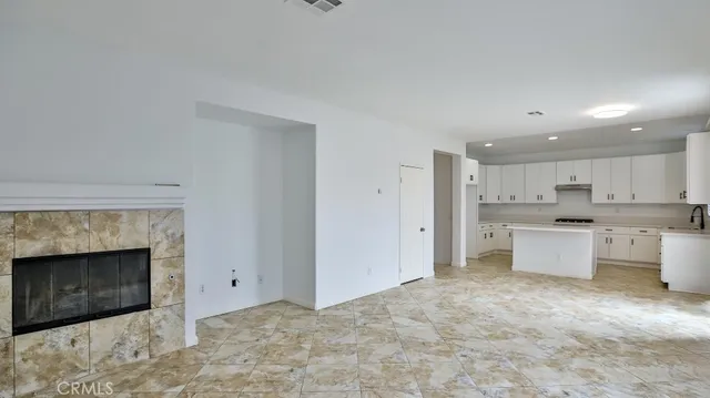 a view of kitchen with kitchen island sink and refrigerator