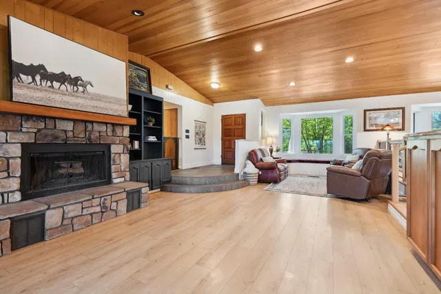 a dining table with chairs and kitchen view