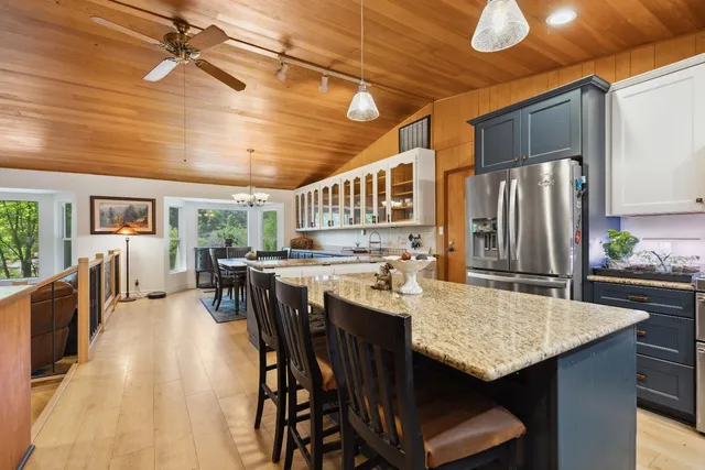 a living room with furniture kitchen view and a fireplace
