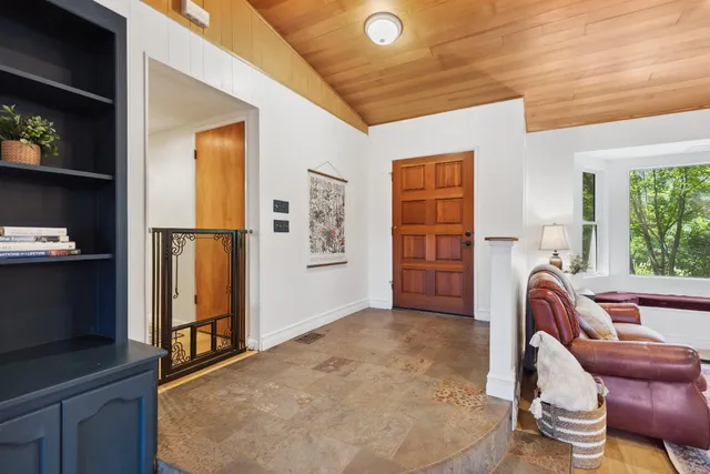 a living room with furniture and a open kitchen view