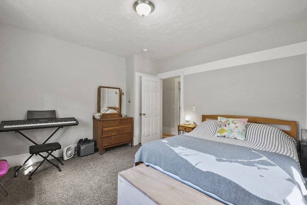 75 Main Street Templeton, MA 01436 - Photo 8 of 33 a bedroom with a bed and chair