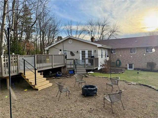 a view of house with a yard outdoor seating and barbeque oven