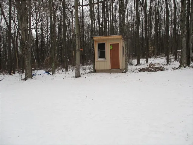 a view of house with yard and sitting area