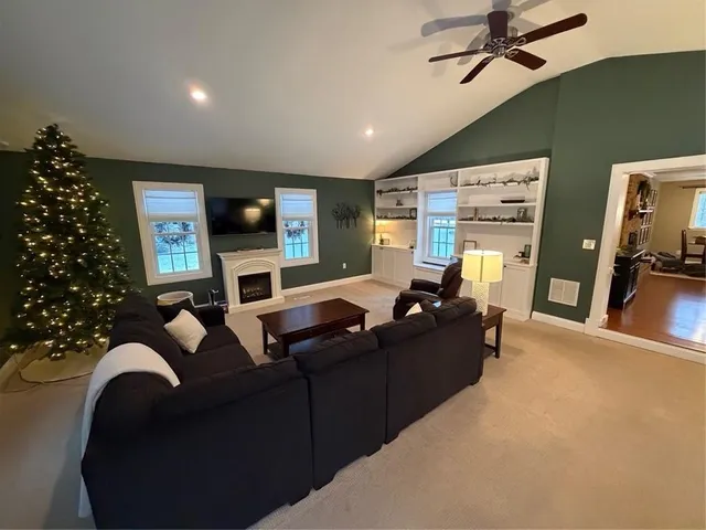 a view of house with yard and sitting area