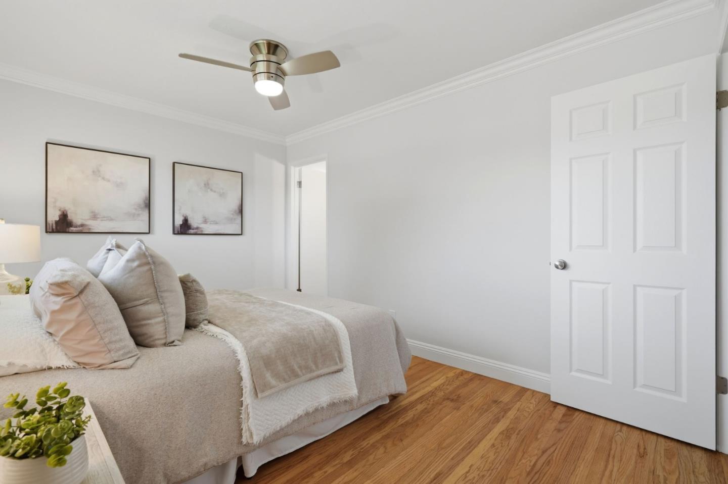 3802 West Rincon Avenue Campbell, CA 95008 - Photo 13 of 27 a bedroom with a bed and wooden floor