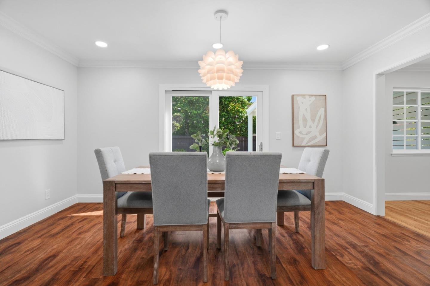3802 West Rincon Avenue San Jose, CA 95008 - Photo 7 of 26 a dining room with furniture a chandelier and wooden floor