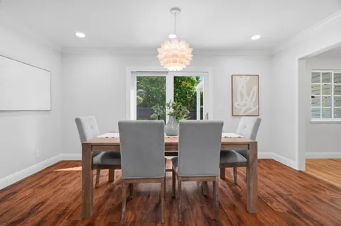 a kitchen with a sink cabinets and wooden floor