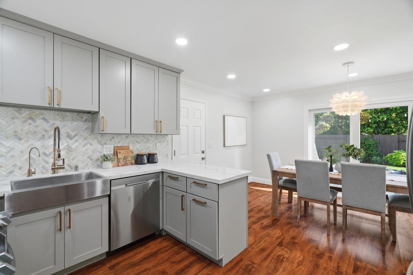 3802 West Rincon Avenue Campbell, CA 95008 - Photo 9 of 27 a kitchen with a sink cabinets and wooden floor