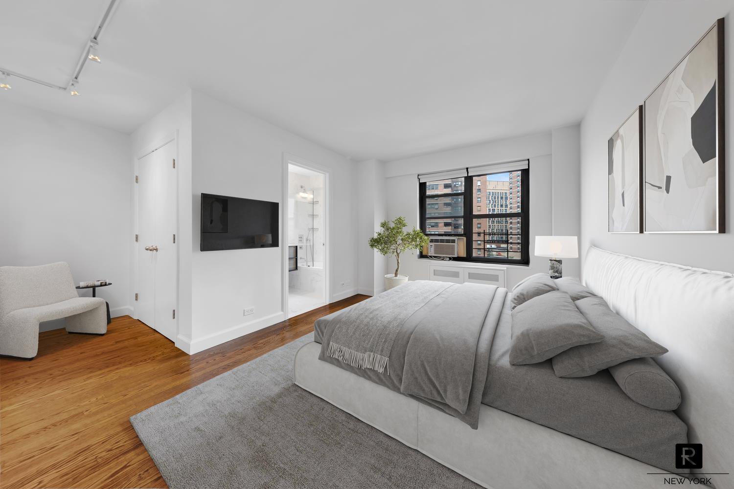 264 East Broadway, Unit C405 Manhattan, NY 10002 - Photo 4 of 12 a bedroom with a bed and a flat screen tv