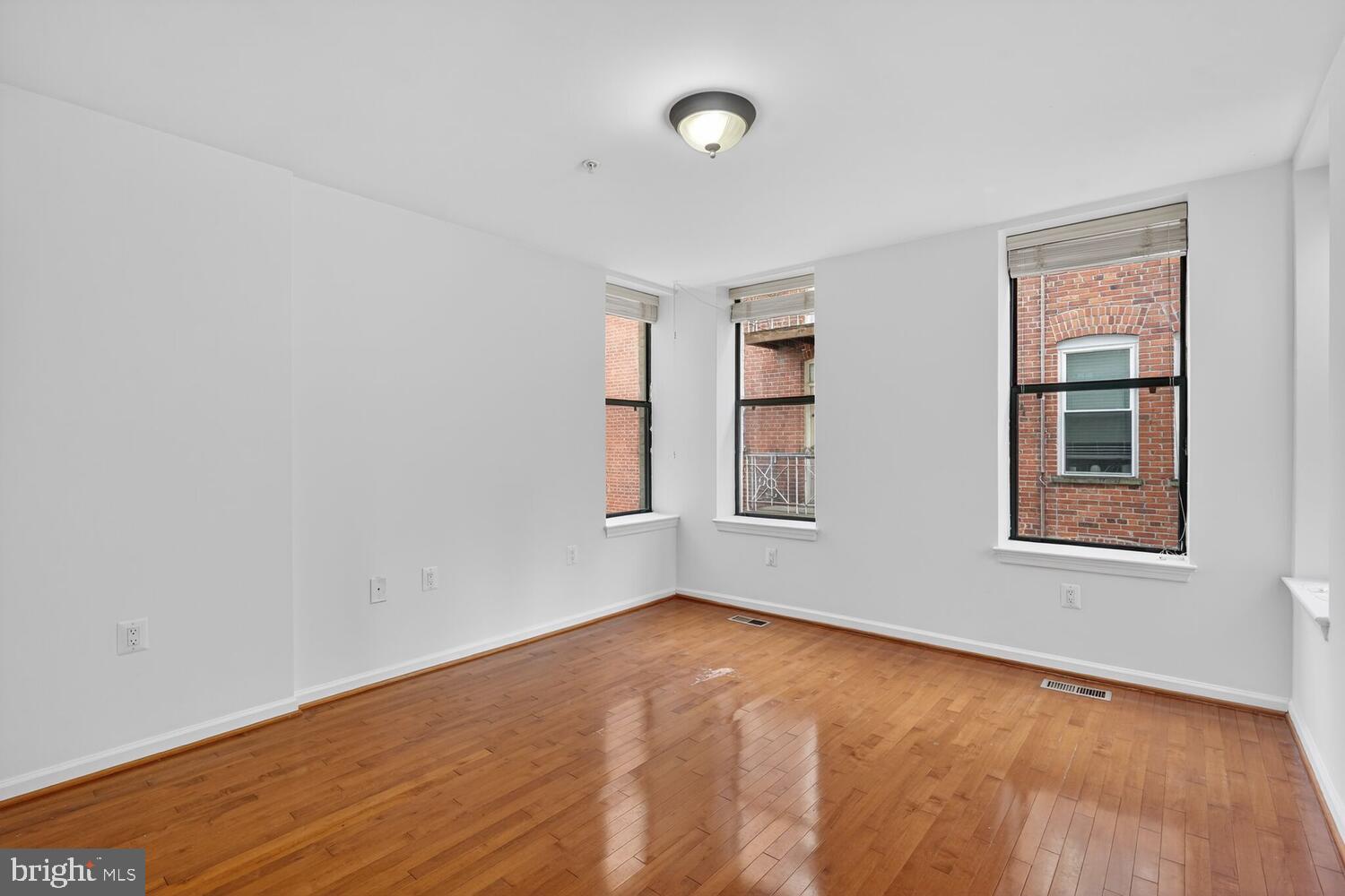 2627 Adams Mill Road Northwest, Unit 104 Washington, DC 20009 - Photo 12 of 16 an empty room with windows