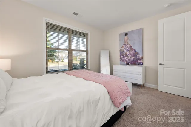 a kitchen with stainless steel appliances granite countertop a table chairs sink refrigerator and cabinets