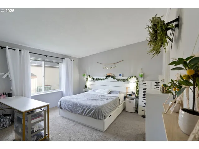 a bedroom with a bed and a potted plant