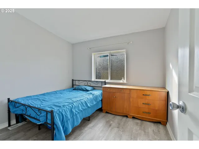 a living room with a bed furniture and mirror