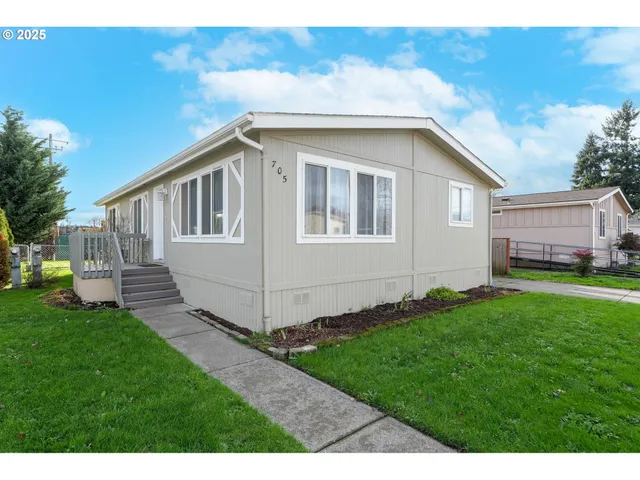 a view of a house with a yard and sitting area
