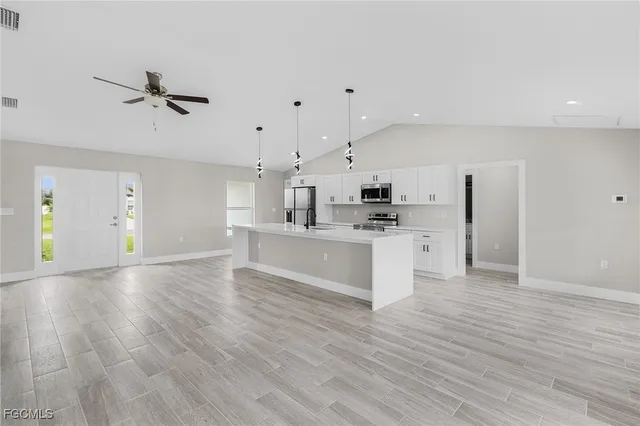 a view of kitchen with cabinets and wooden floor