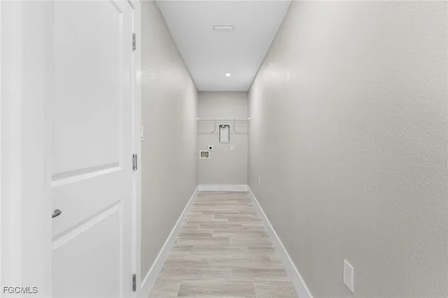 a view of a hallway with wooden floor