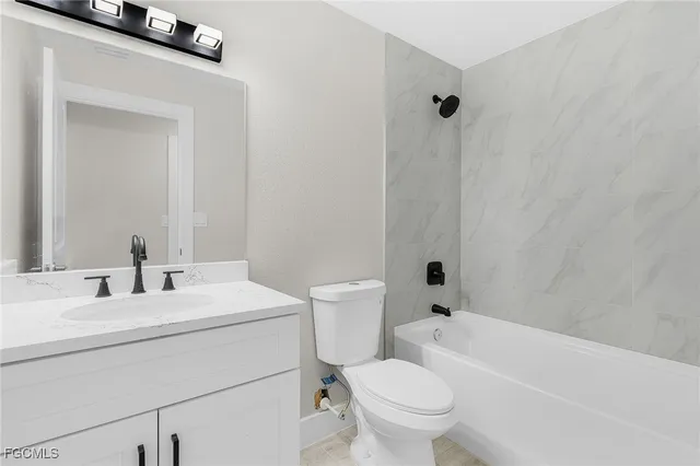 a bathroom with a toilet a sink and a bathtub