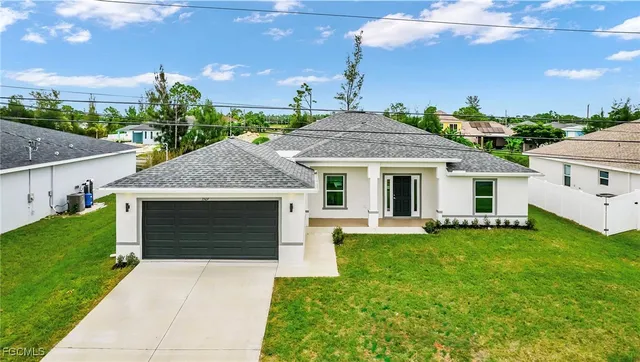 a front view of a house with a garden and plants