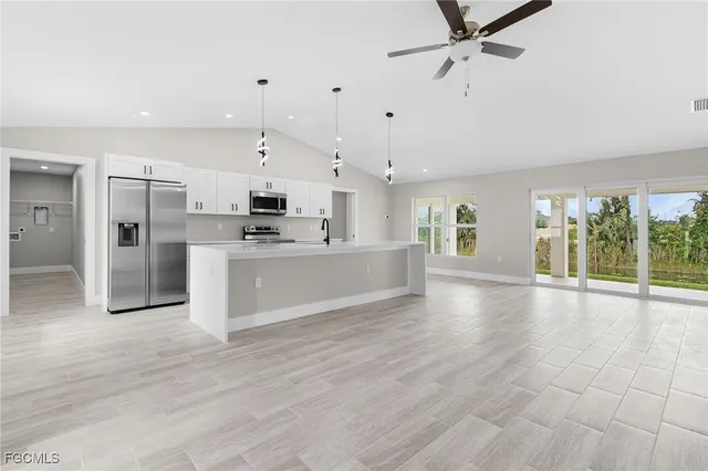 a view of a kitchen with a stove cabinets and wooden floor