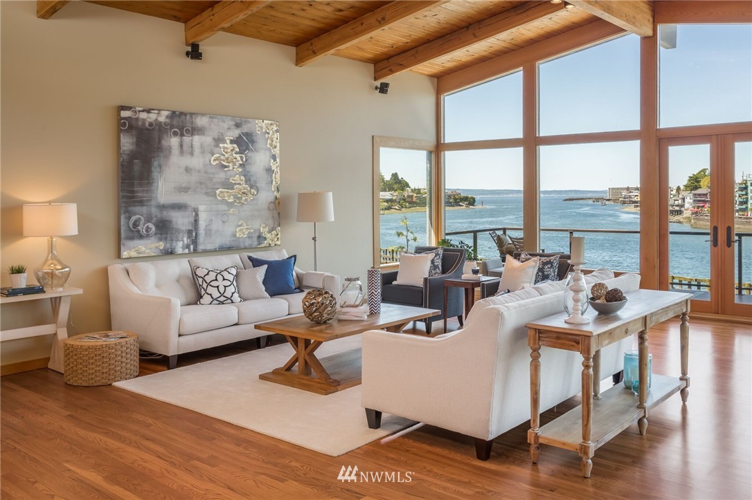 3500 West Commodore Way Seattle, WA 98199 - Photo 2 of 25 a living room with furniture large windows and wooden floor