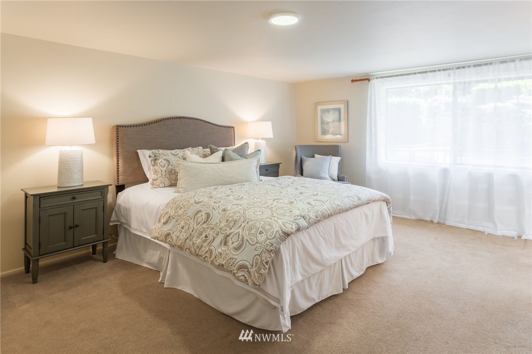 3500 West Commodore Way Seattle, WA 98199 - Photo 13 of 25 a bedroom with a bed and a night stand