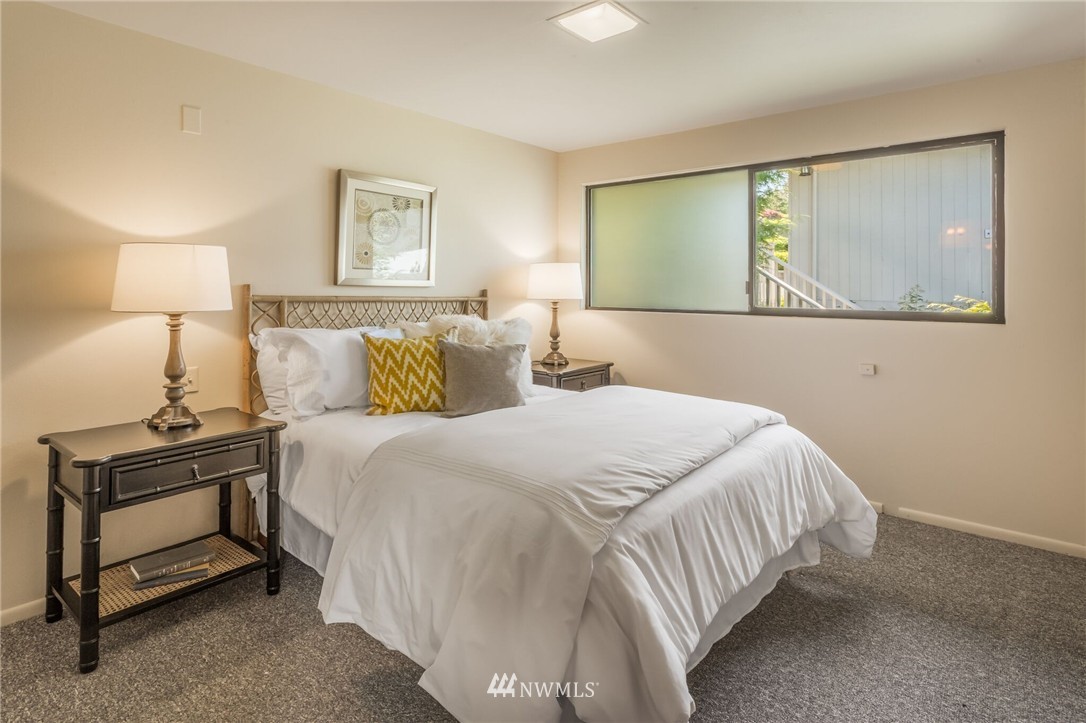 3500 West Commodore Way Seattle, WA 98199 - Photo 14 of 25 a bedroom with a bed and night stand