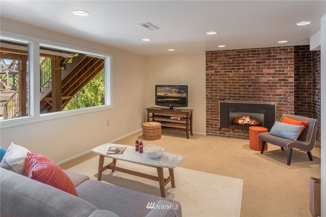 3500 West Commodore Way Seattle, WA 98199 - Photo 16 of 25 a living room with furniture fireplace and flat screen tv