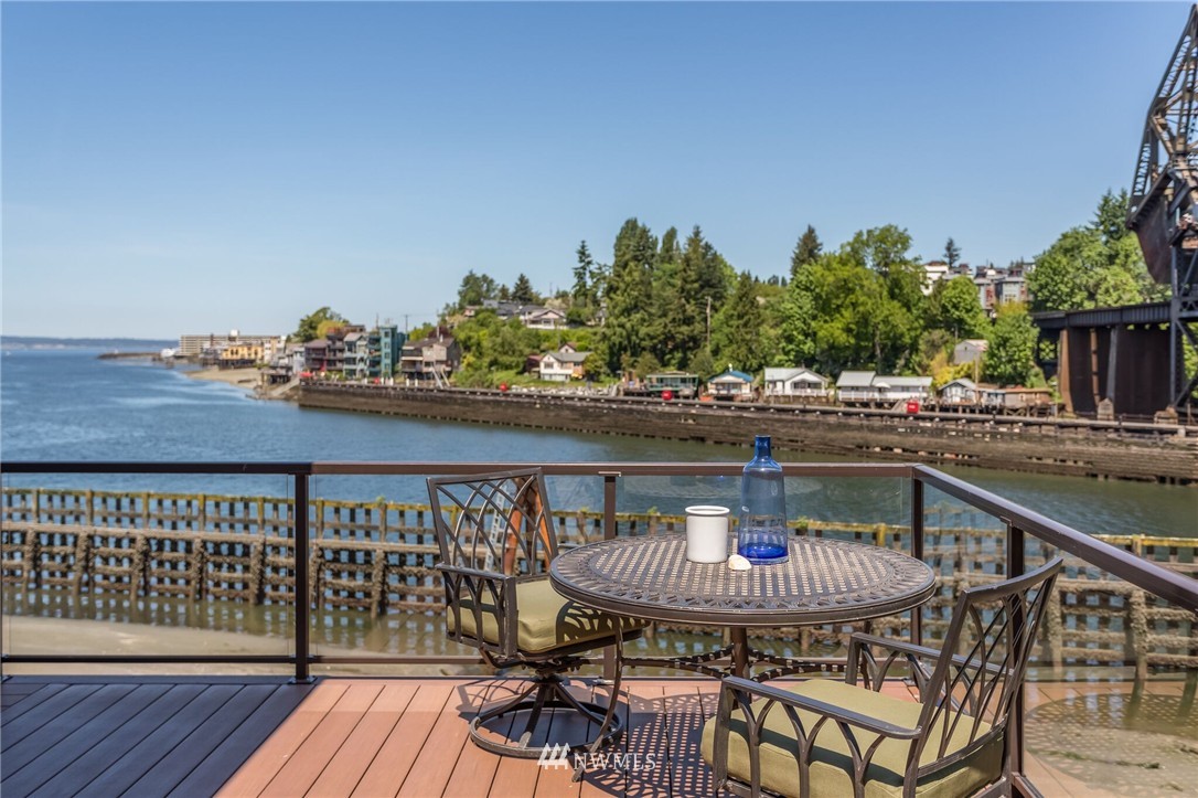 3500 West Commodore Way Seattle, WA 98199 - Photo 25 of 25 a balcony with wooden floor table and chairs