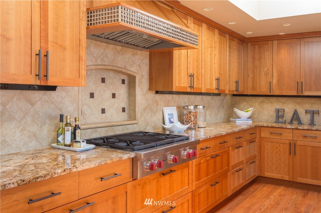 3500 West Commodore Way Seattle, WA 98199 - Photo 8 of 25 a kitchen with stainless steel appliances granite countertop a sink stove and cabinets