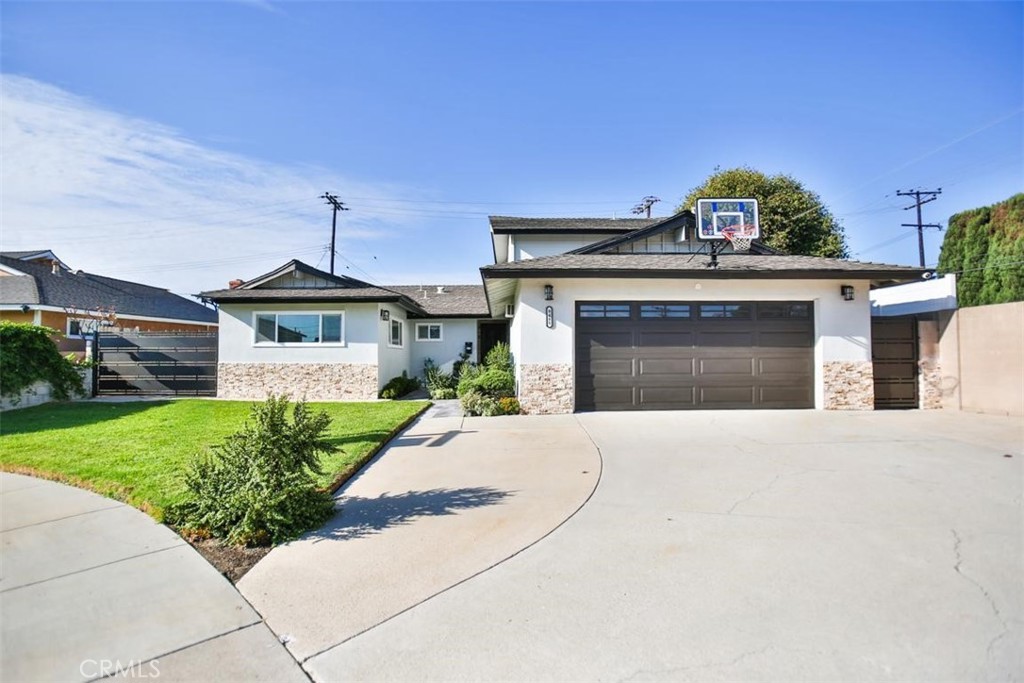 9485 Geranium Circle Fountain Valley, CA 92708 - Photo 5 of 36 a front view of a house with a garden and plants