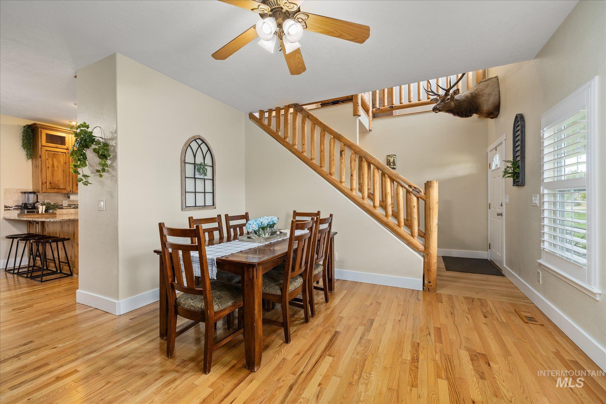 1140 Edgemont Road Emmett, ID 83617 - Photo 12 of 50 Expansive main level featuring wood-finish flooring, a rustic wood staircase, and plantation shutters