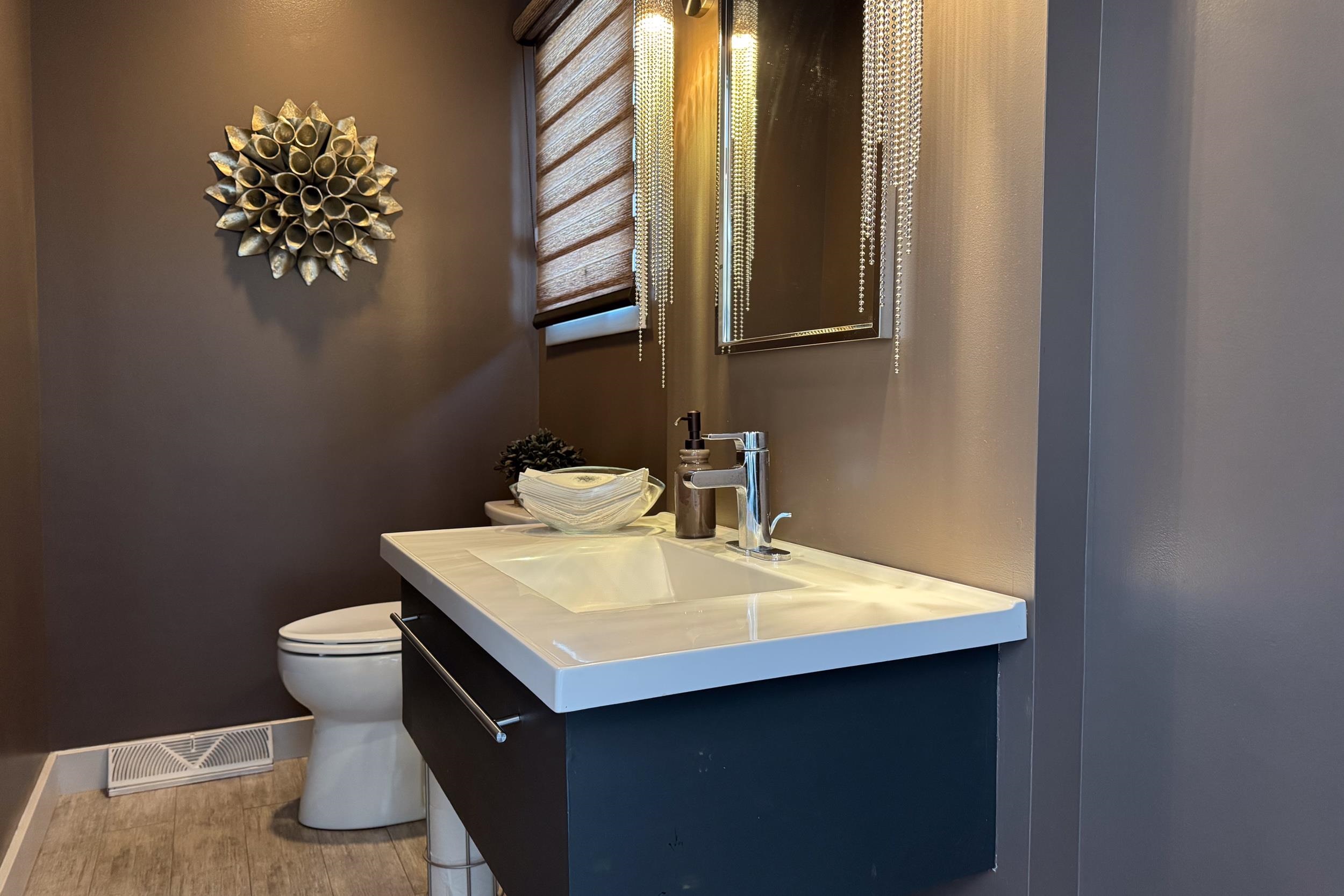 6811 West Gate Road Roscoe, IL 61073 - Photo 13 of 61 a bathroom with a sink toilet and mirror