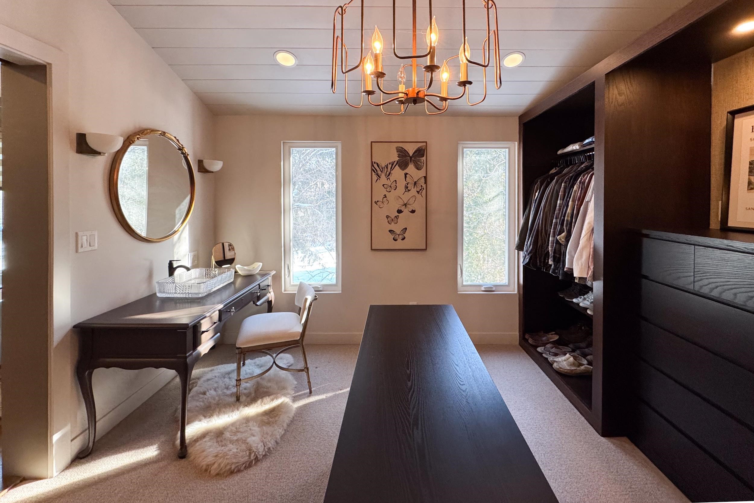 6811 West Gate Road Roscoe, IL 61073 - Photo 28 of 61 a living room with furniture a mirror and a chandelier