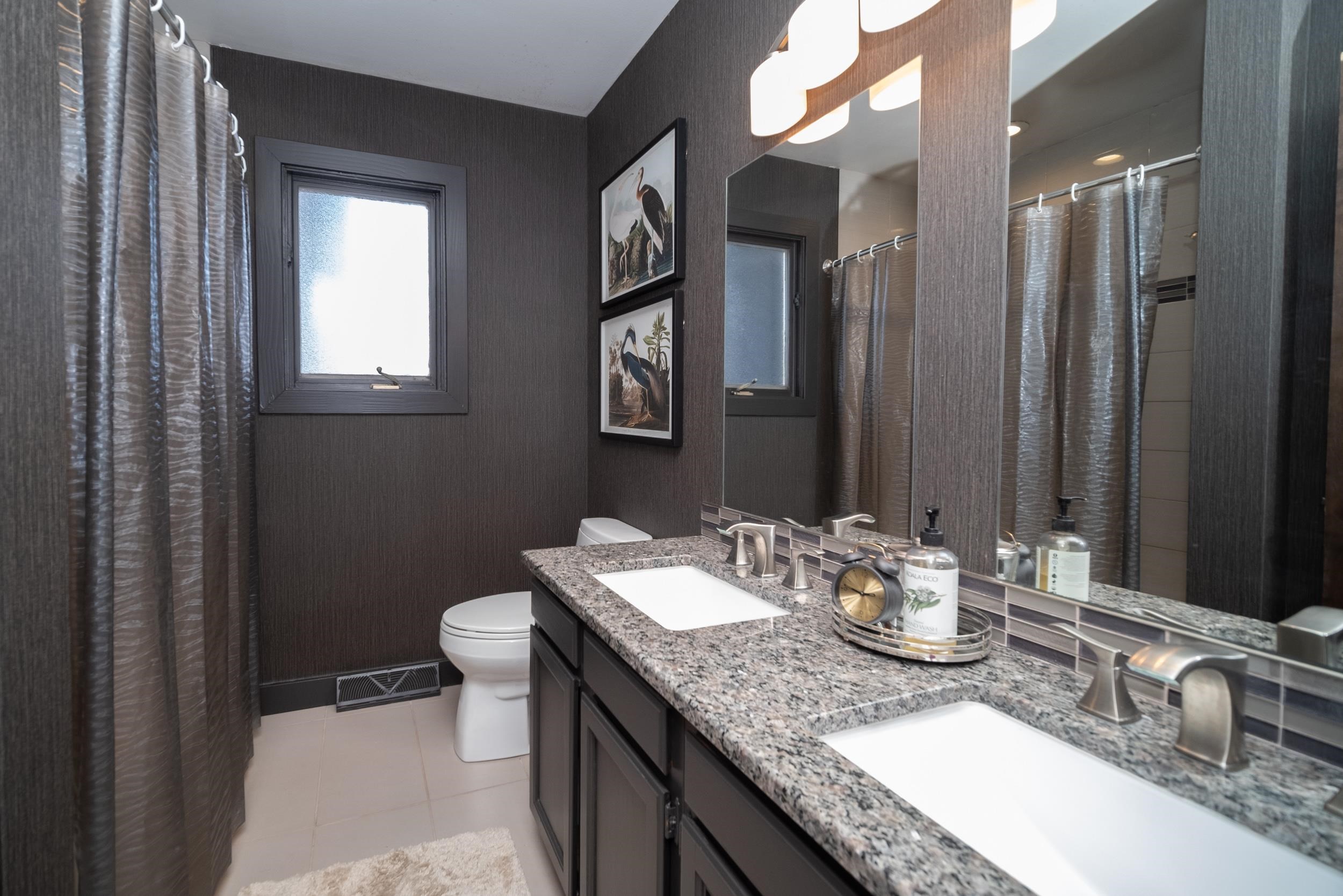 6811 West Gate Road Roscoe, IL 61073 - Photo 35 of 61 a bathroom with a granite countertop sink mirror and toilet