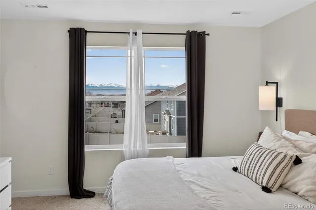 a bedroom with a bed and glass door