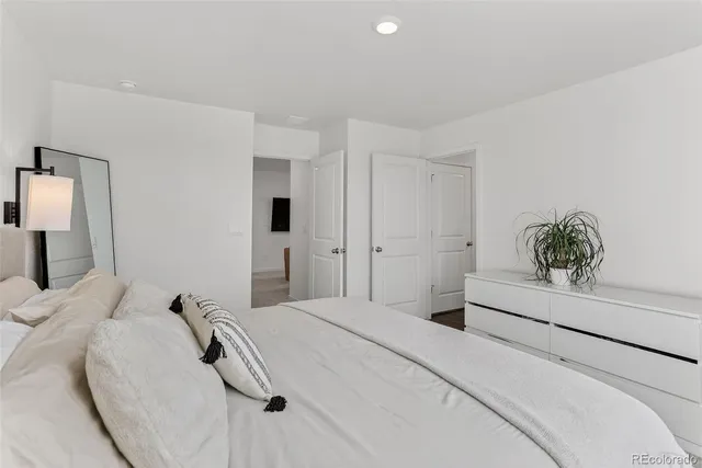 a bedroom with a bed and a painting on the wall