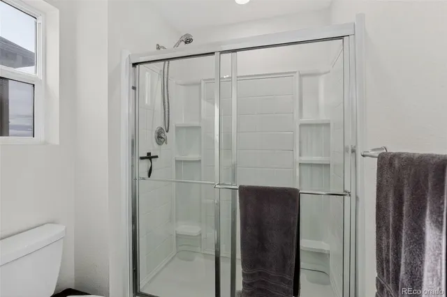 a bathroom with a shower and a toilet