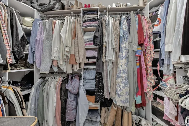 a view of walk in closet with clothes